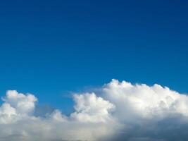 White fluffy cumulus clouds in the summer sky, natural clouds background photo