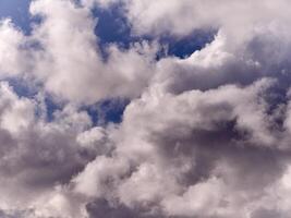 White fluffy cumulus clouds in the summer sky, natural clouds background photo