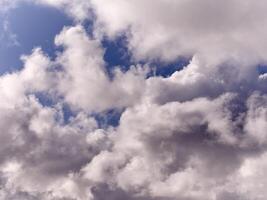 White fluffy cumulus clouds in the summer sky, natural clouds background photo