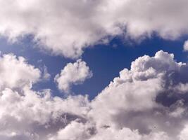 White fluffy cumulus clouds in the summer sky, natural clouds background photo