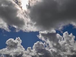 White cumulus clouds in the deep blue summer sky. Fluffy clouds background photo