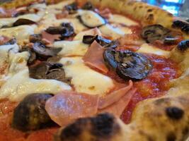 Tasty pizza close view background. Italian pizzeria atmosphere photo