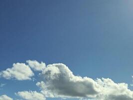 White fluffy cumulus clouds in the summer sky, natural clouds background photo