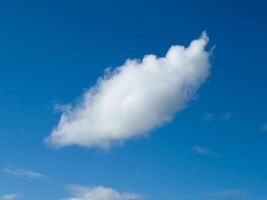 soltero blanco mullido cúmulo nube en el azul verano cielo foto