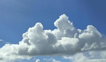 White fluffy cumulus clouds background. Summer clouds in the blue sky photo