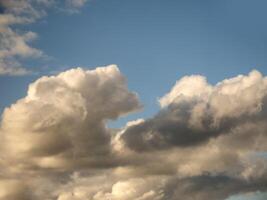 White fluffy cumulus clouds in the summer sky, natural clouds background photo