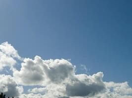 White fluffy cumulus clouds in the summer sky, natural clouds background photo