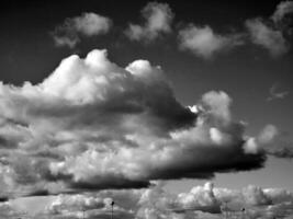 Black and white clouds in the sky background photo