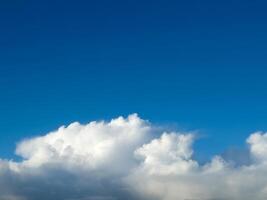 White fluffy cumulus clouds in the summer sky, natural clouds background photo