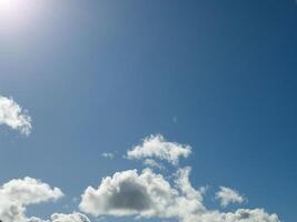 White fluffy cumulus clouds in the summer sky, natural clouds background photo