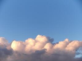 White fluffy cumulus clouds in the summer sky, natural clouds background photo