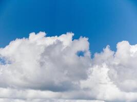 White fluffy cumulus clouds in the summer sky, natural clouds background photo