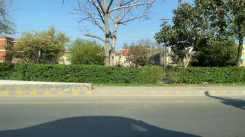 Side view of service road during driving in vehicle in Lahore Pakistan on March 22, 2024 video