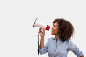 Black woman holding a megaphone. makes a powerful change. Spread the news by announcing photo