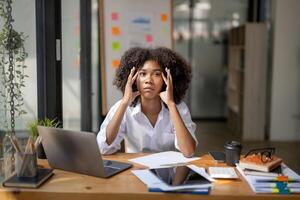 Businesswoman sitting stressed with work on the desk in the office, There was a problem in the work that was done. photo