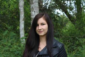 A Beautiful Young Woman in a Black Leather Jacket. photo