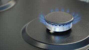 Gas burner on stove being turned off. Gas deficit, gas savings video
