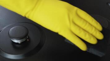 Close up of woman cleaning gas stove at home kitchen. Cleaning and tidying the household gas stove video