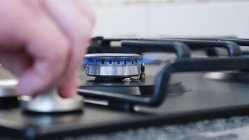 Close up of turning on gas stove top and putting a pot on it video