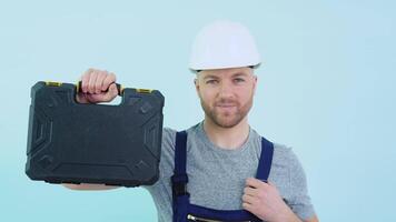 Serviceman in overalls showing his tools video
