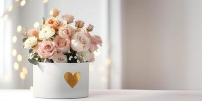 A bouquet of delicate pastel white and pink roses in a white package with gold hearts. Festive light background with copy space photo