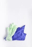 Rubber gloves and microfiber cloth for cleaning on light background photo