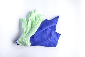 Rubber gloves and microfiber cloth for cleaning on light background photo