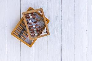 Vintage wooden abacus on old board surface. photo