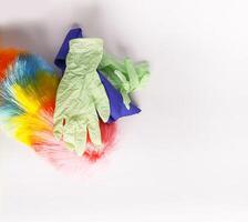 Rubber gloves, the duster and microfiber cloth on light background photo