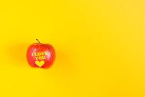 Fresh red apple with words I love you and heart photo