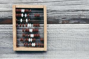 Vintage wooden abacus on old board surface. photo