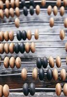 Vintage wooden abacus on old board surface. photo