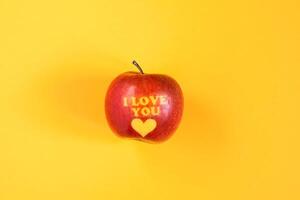 Fresh red apple with words I love you and heart photo