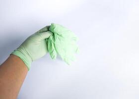 Woman's hand holds the rubber glove photo