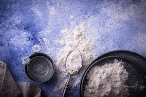 Wheat flour on dark. Baking background photo