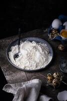 Baking ingredients with flour and eggs photo