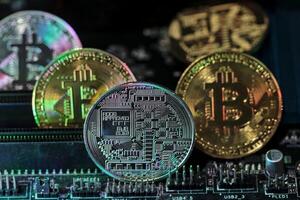 Bitcoin coins on computer equipment The concept of digital coin prices goes down and stops mining. photo