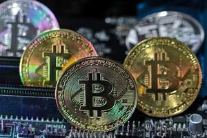 Bitcoin coins on computer equipment The concept of digital coin prices goes down and stops mining. photo