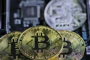 Bitcoin coins on computer equipment The concept of digital coin prices goes down and stops mining. photo