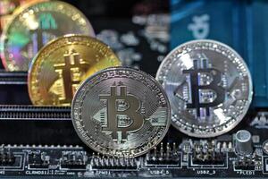 Bitcoin coins on computer equipment The concept of digital coin prices goes down and stops mining. photo