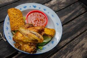 Traditional food of Javanese chicken, tofu, tempe and chili sauce. The photo is suitable to use for traditional food background and snack content media