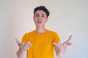 Young man with why pose, asking gesture. The photo is suitable to use for man expression advertising and fashion life style.