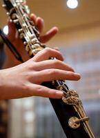 Close up of children's hands playing the clarinet in a music studio photo