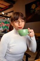 Portrait of a woman with a cup of coffee in a cafe photo