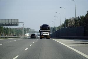 Truck With Cars on a Highway photo