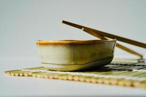 chopsticks and bowl of soy sauce photo