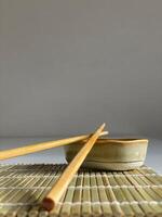 chopsticks and bowl of soy sauce photo