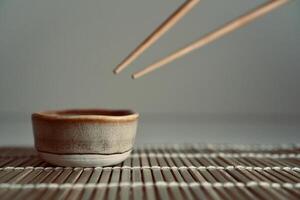 chopsticks and bowl of soy sauce photo