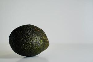 a green avocado on a white background photo