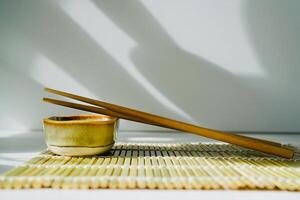 chopsticks and bowl of soy sauce photo